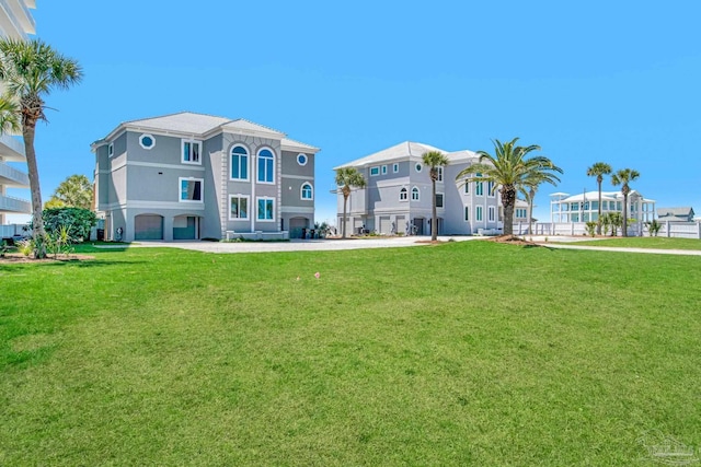 rear view of property featuring a lawn
