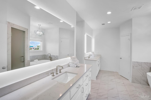 full bathroom featuring marble look tile flooring, recessed lighting, two vanities, a soaking tub, and a stall shower