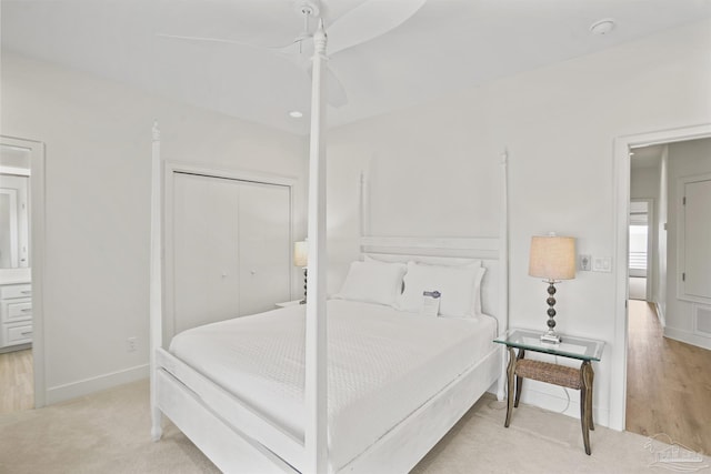 bedroom featuring a closet, baseboards, a ceiling fan, and light carpet