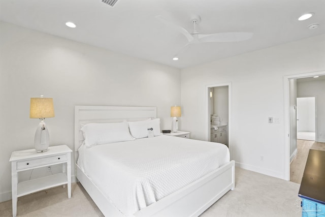 bedroom featuring recessed lighting, baseboards, light carpet, ensuite bathroom, and a ceiling fan
