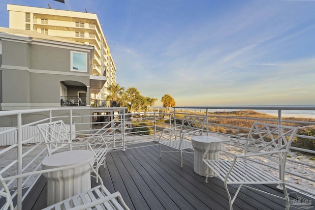 wooden deck featuring a water view