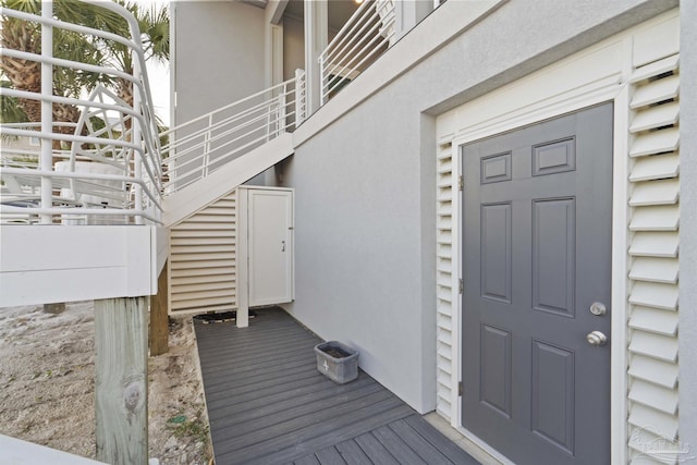 property entrance with stucco siding