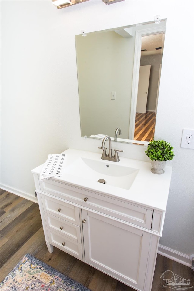 bathroom with vanity and wood finished floors