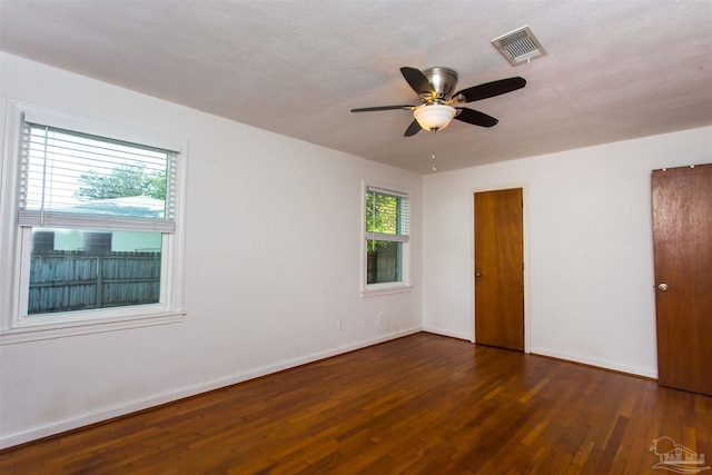 unfurnished bedroom featuring wood finished floors, ceiling fan, baseboards, and visible vents