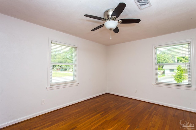 unfurnished room with visible vents, hardwood / wood-style flooring, baseboards, and ceiling fan