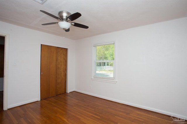 unfurnished bedroom with a closet, baseboards, a ceiling fan, and wood finished floors