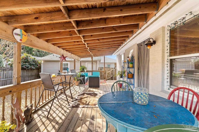 wooden deck with fence and outdoor dining area