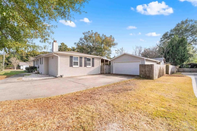 single story home with concrete driveway, a front lawn, fence, and a chimney