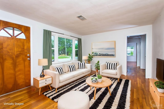 living room with visible vents and wood finished floors