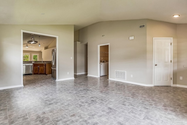 spare room with washer / dryer, lofted ceiling, and sink