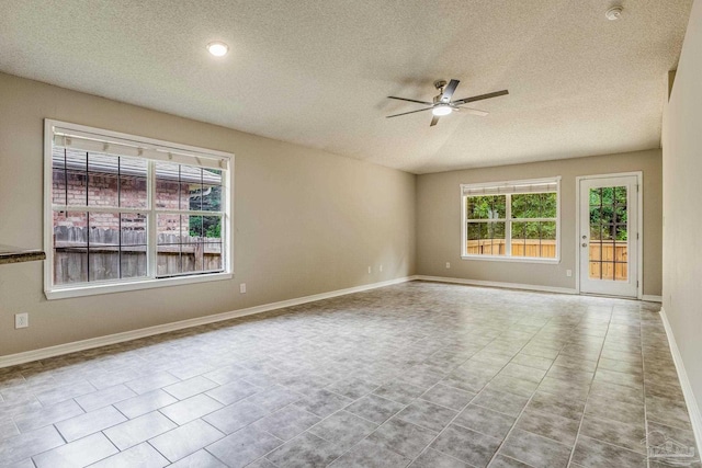 unfurnished room featuring light tile patterned floors, a textured ceiling, and ceiling fan