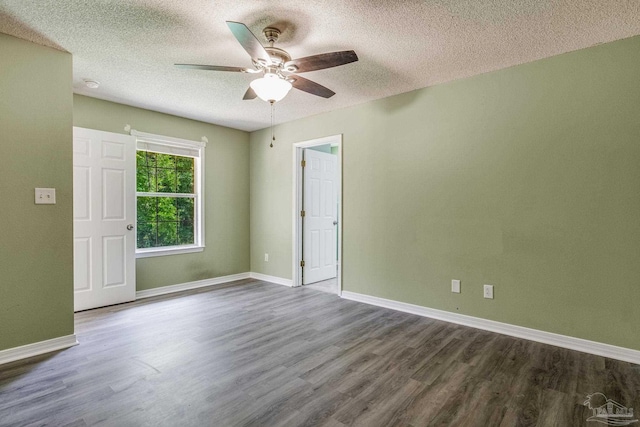 empty room with ceiling fan, hardwood / wood-style floors, and a textured ceiling