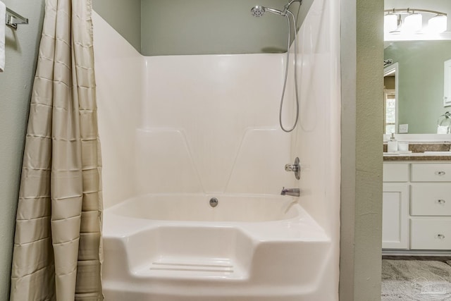 bathroom featuring shower / tub combo and vanity