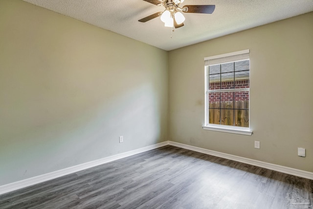 unfurnished room with ceiling fan, a textured ceiling, and dark hardwood / wood-style flooring