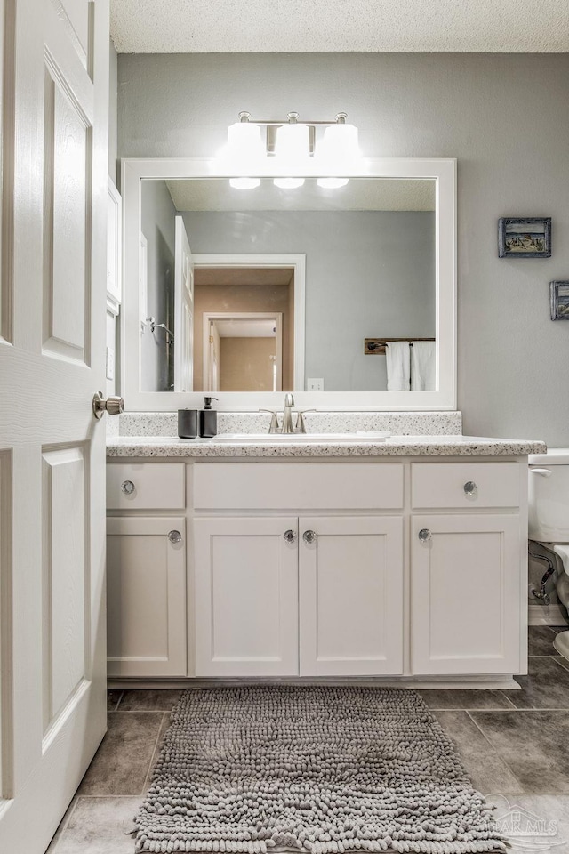 bathroom with tile patterned floors, vanity, and toilet