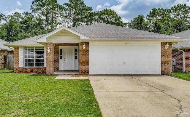 ranch-style house featuring a garage and a front lawn