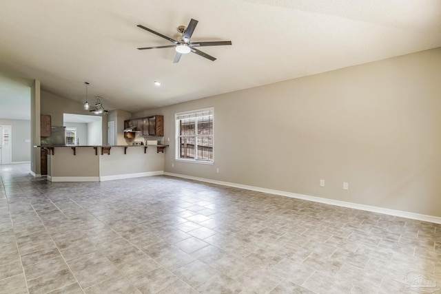 unfurnished living room featuring light tile patterned flooring, lofted ceiling, and ceiling fan