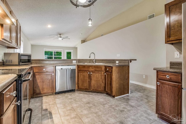 kitchen featuring appliances with stainless steel finishes, sink, custom exhaust hood, ceiling fan, and kitchen peninsula