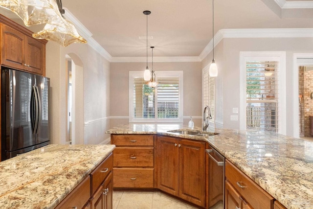 kitchen featuring arched walkways, stainless steel appliances, a sink, light stone countertops, and brown cabinetry