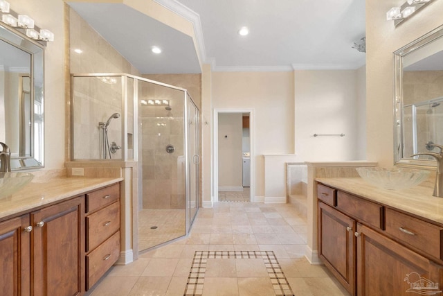 bathroom featuring crown molding, two vanities, a sink, a shower stall, and baseboards