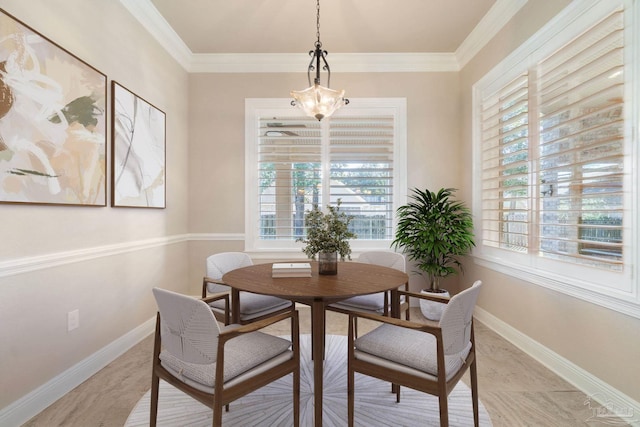 dining area with a wealth of natural light, crown molding, and baseboards