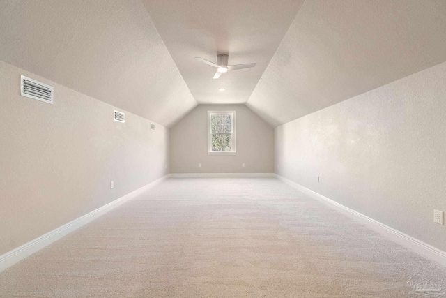 bonus room with lofted ceiling, carpet floors, visible vents, and baseboards