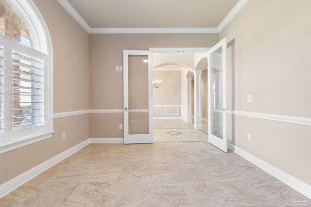 spare room with arched walkways, french doors, and a healthy amount of sunlight