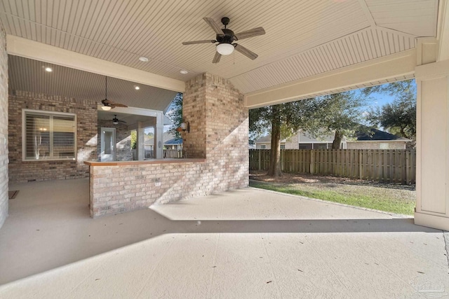 view of patio featuring fence and a ceiling fan