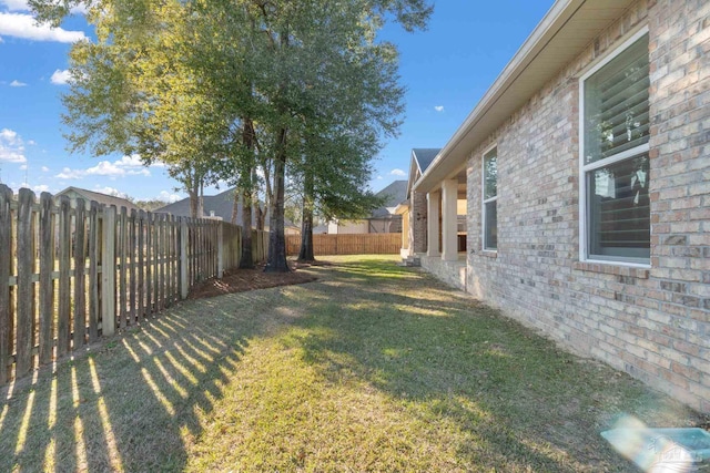 view of yard with a fenced backyard