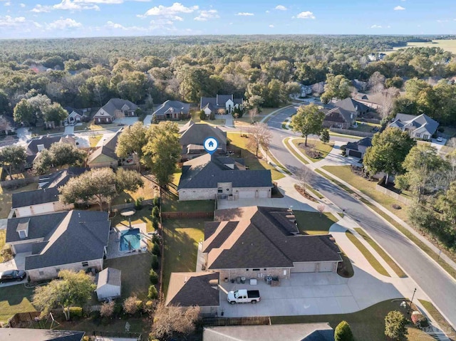 drone / aerial view with a forest view and a residential view