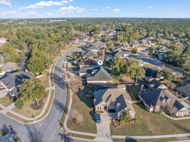 bird's eye view featuring a forest view and a residential view