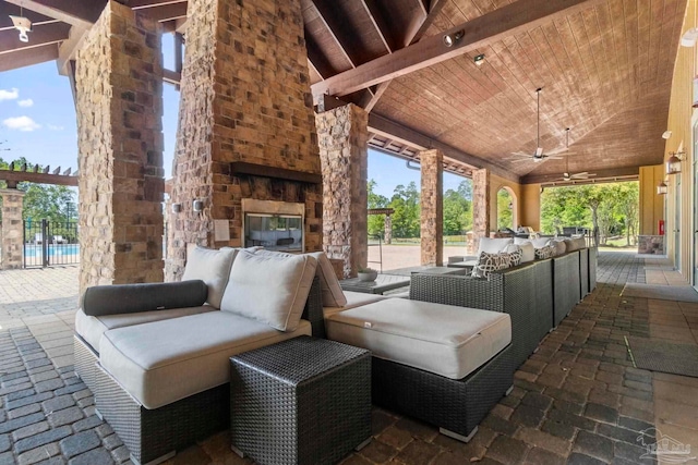 view of patio featuring an outdoor living space with a fireplace and ceiling fan