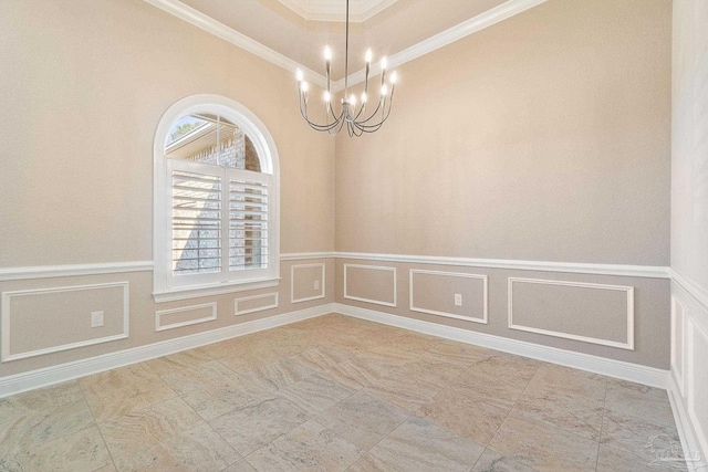 unfurnished room with crown molding, a wainscoted wall, a notable chandelier, and a decorative wall