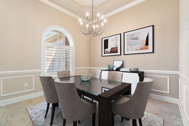 dining area with a wainscoted wall, a decorative wall, and a notable chandelier