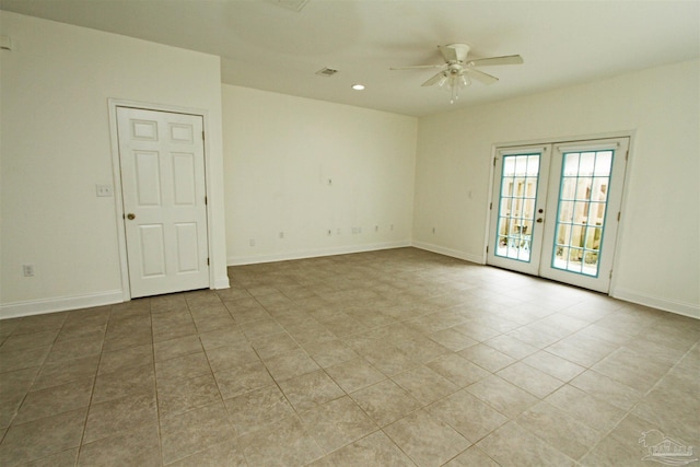 empty room featuring french doors, ceiling fan, and light tile patterned floors