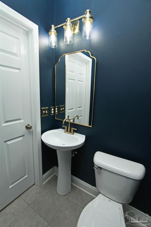 bathroom featuring tile patterned flooring and toilet