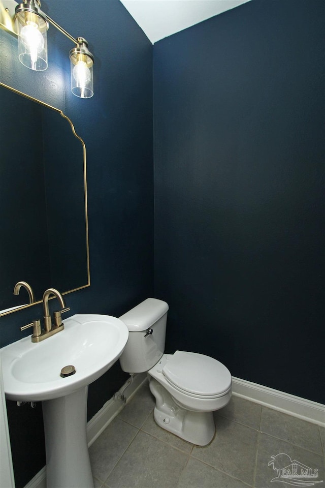 bathroom featuring toilet and tile patterned flooring