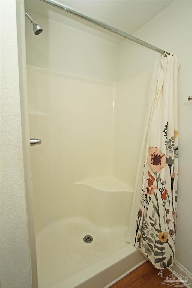 bathroom featuring a shower with curtain and wood-type flooring