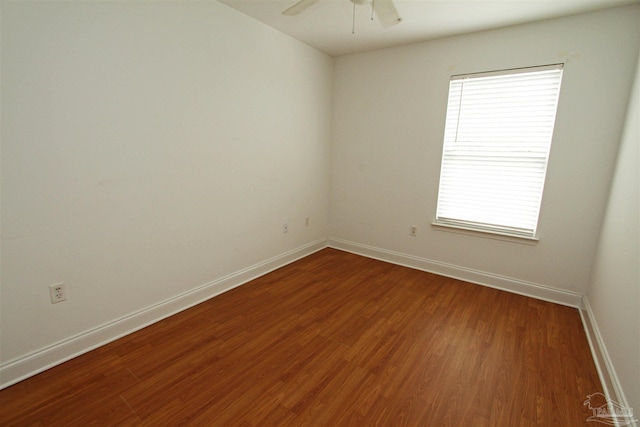 empty room with hardwood / wood-style floors and ceiling fan