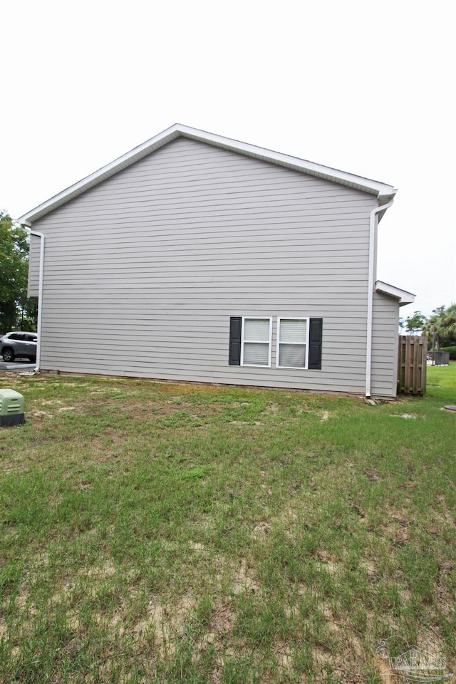 view of side of home featuring a yard