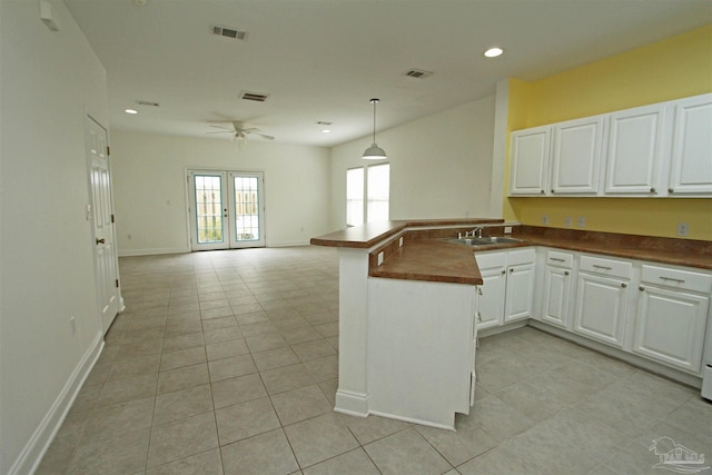 kitchen featuring light tile patterned flooring, sink, ceiling fan, and white cabinets