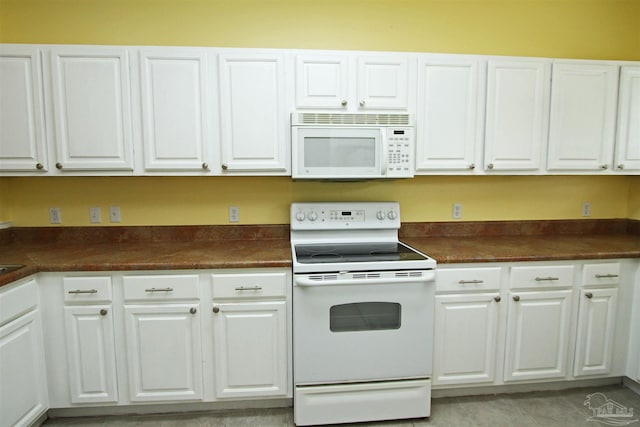 kitchen featuring white cabinetry and white appliances