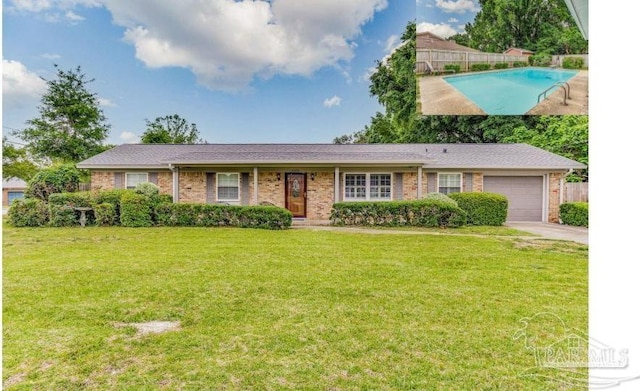 ranch-style home with a garage, a fenced in pool, and a front yard