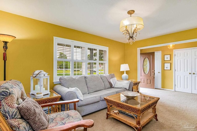 living room featuring carpet floors and a chandelier