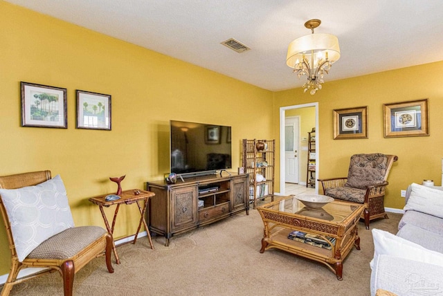 carpeted living room featuring a chandelier