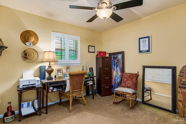 carpeted office space with ceiling fan