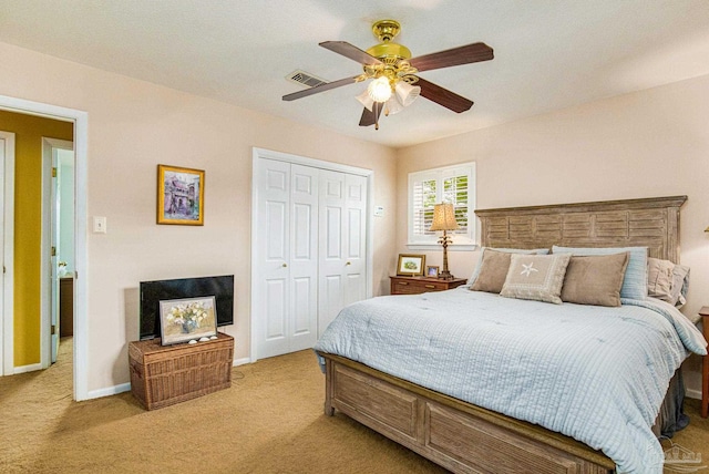 bedroom with a closet, light colored carpet, and ceiling fan