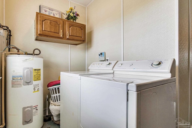 laundry room with cabinets, water heater, and separate washer and dryer