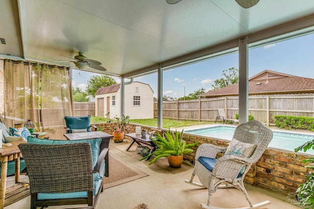 view of patio with a fenced in pool, ceiling fan, and an outdoor structure