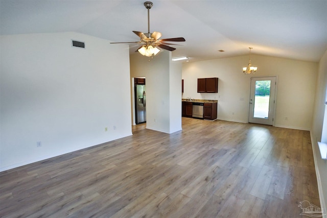 2608 Salamanca St, Navarre, FL 32566 - unfurnished living room featuring lofted ceiling, a chandelier, light wood finished floors, and a ceiling fan